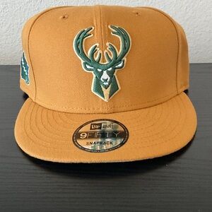 New Era Mustard Yellow Snapback with Green Bucks Logo